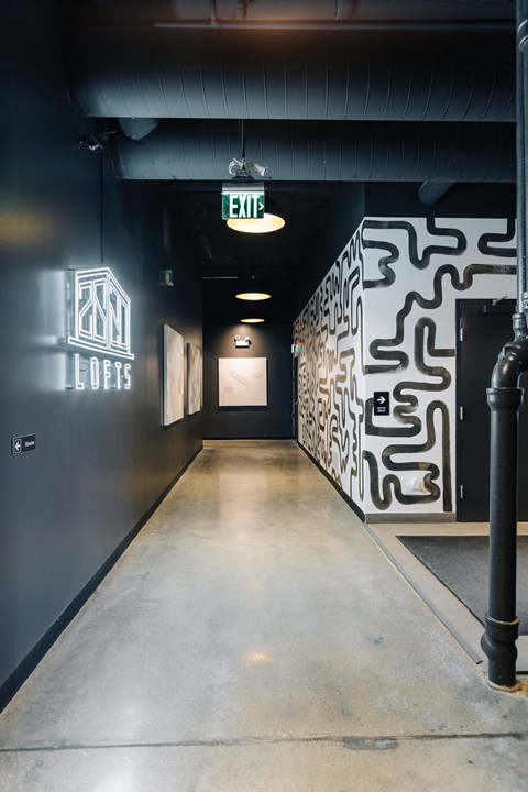 A hallway with a Lofts sign on the wall.