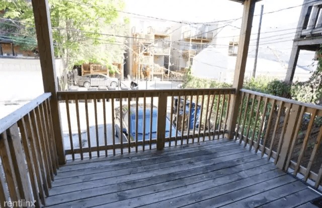 the deck has a view of the street and the house