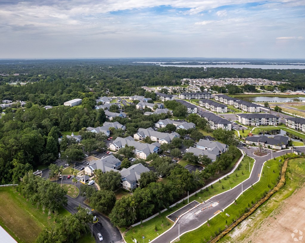 A bird's eye view of a residential area with houses and roads.