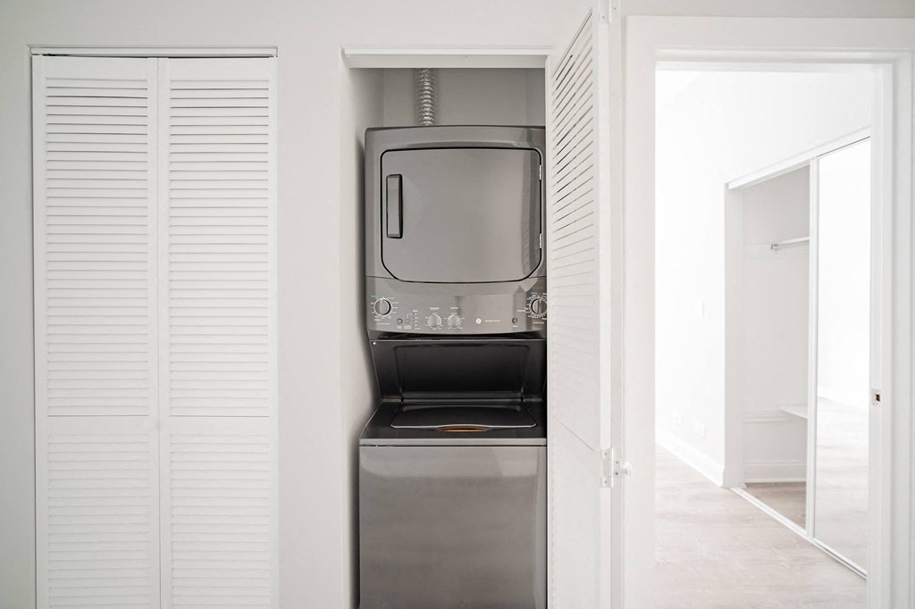 a small refrigerator and a microwave in a closet