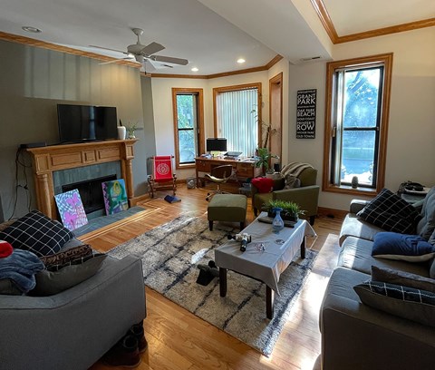 A living room with a fireplace and a television.