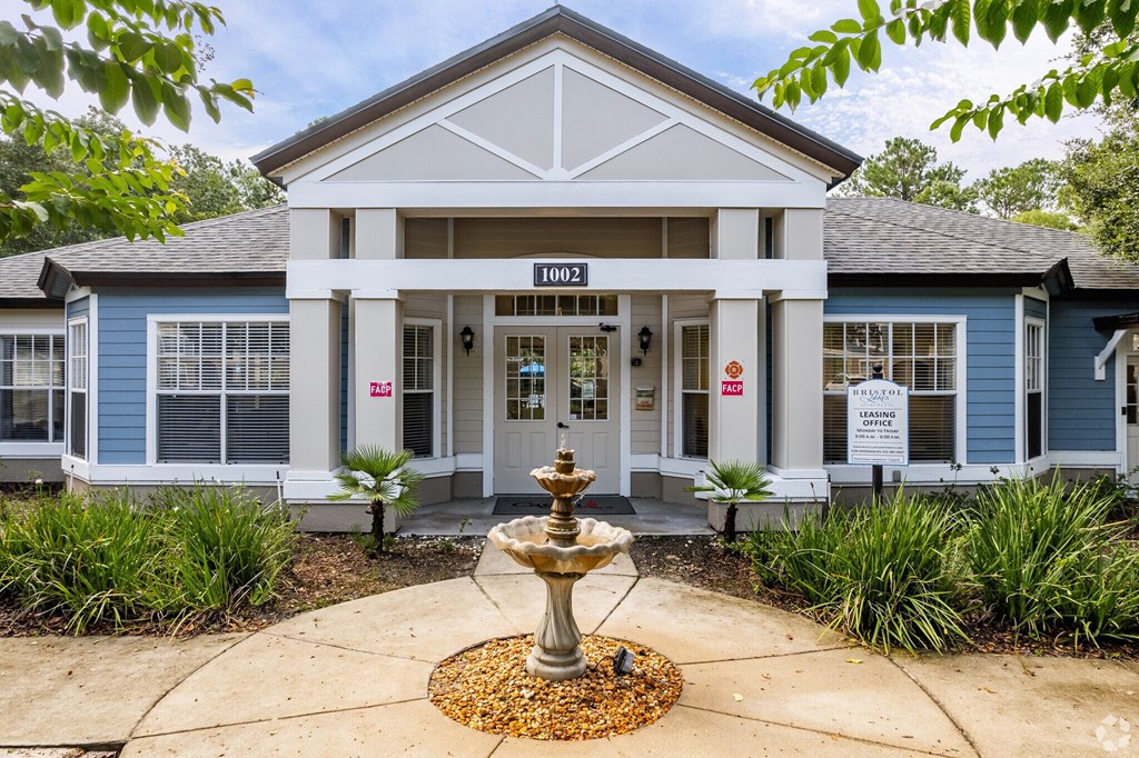A blue building with a fountain in front of it.