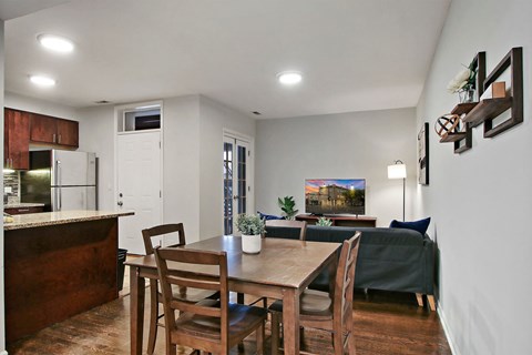A kitchen with a table and chairs in the middle of the room.