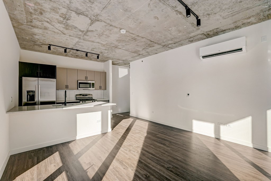 A kitchen with a white counter and a white fridge.