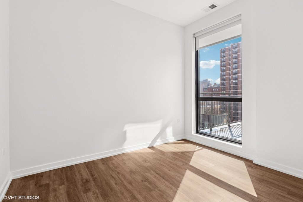 A room with a window overlooking a cityscape.