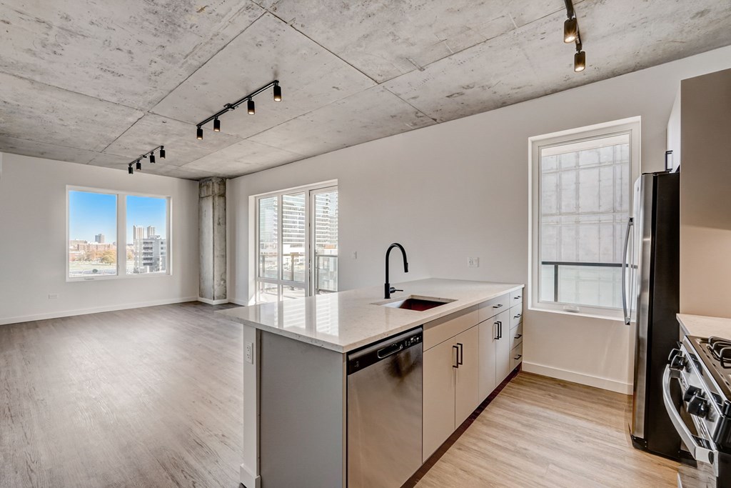 A kitchen with a large island and stainless steel appliances.