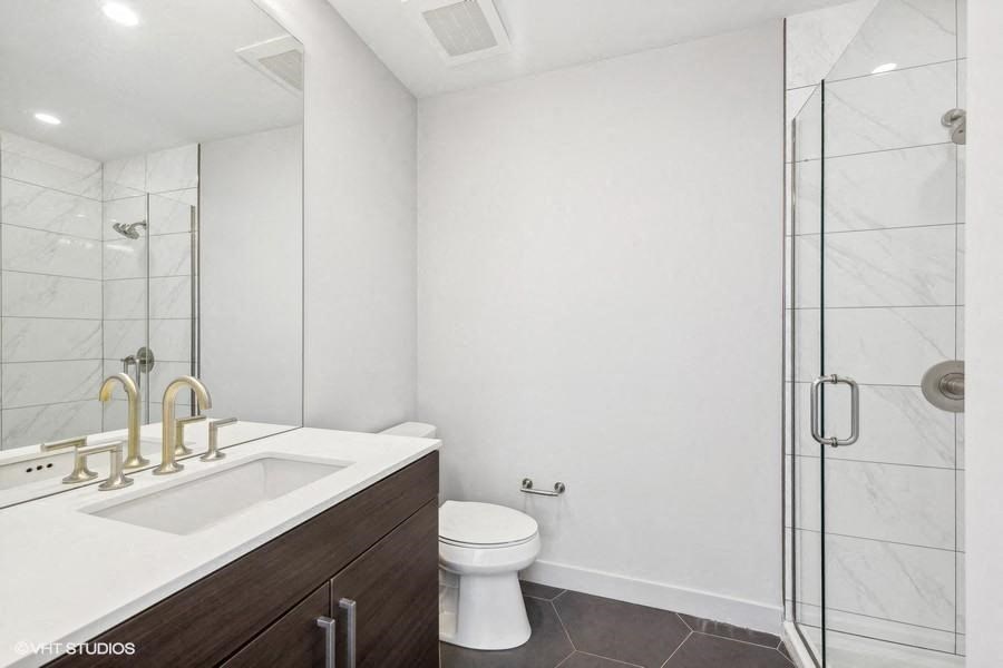 a bathroom with a sink toilet and a shower