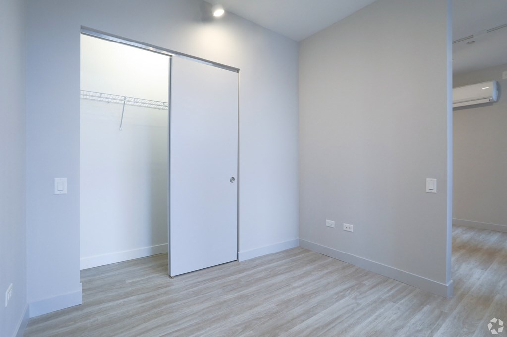 an empty room with a sliding closet door