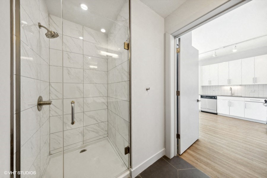 a woman walking in a room with a wall of stars