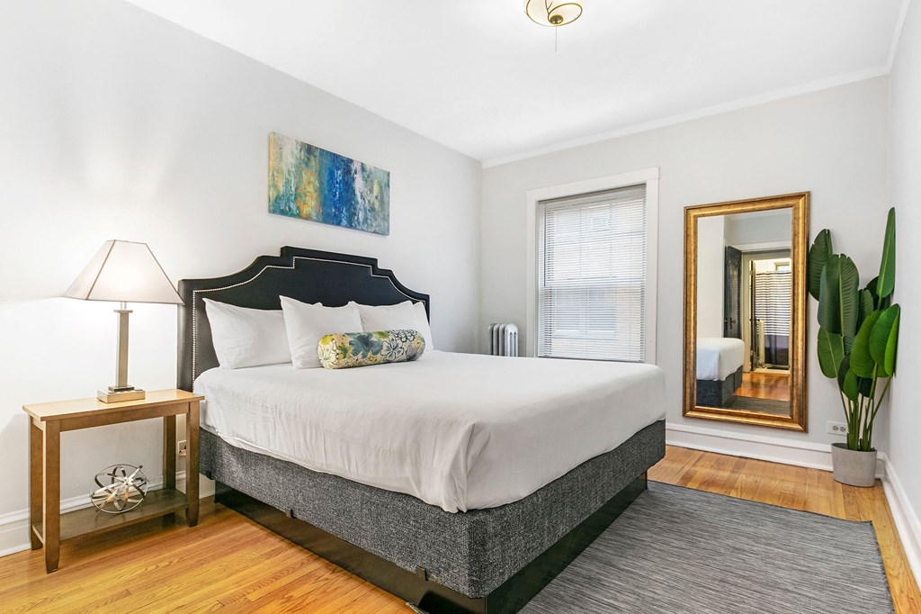 a bedroom with a bed and a mirror