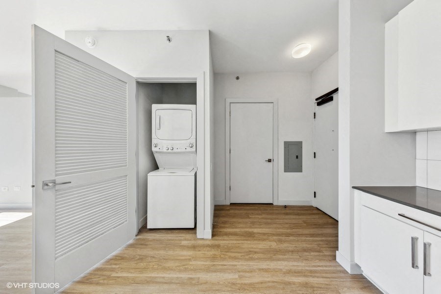 a white kitchen with a washer and dryer in it