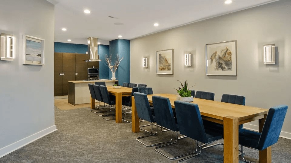 A conference room with a long table and chairs.
