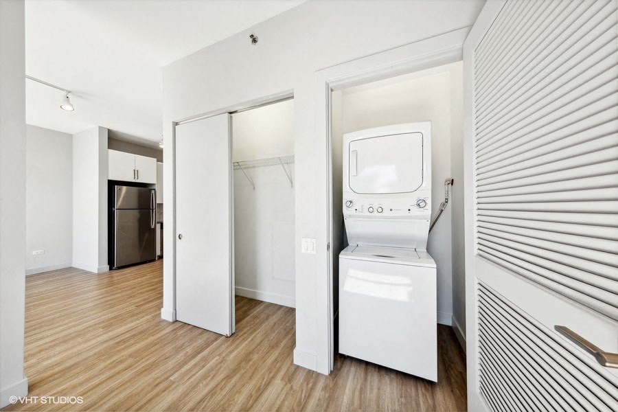 an empty room with a washing machine and a dryer in it