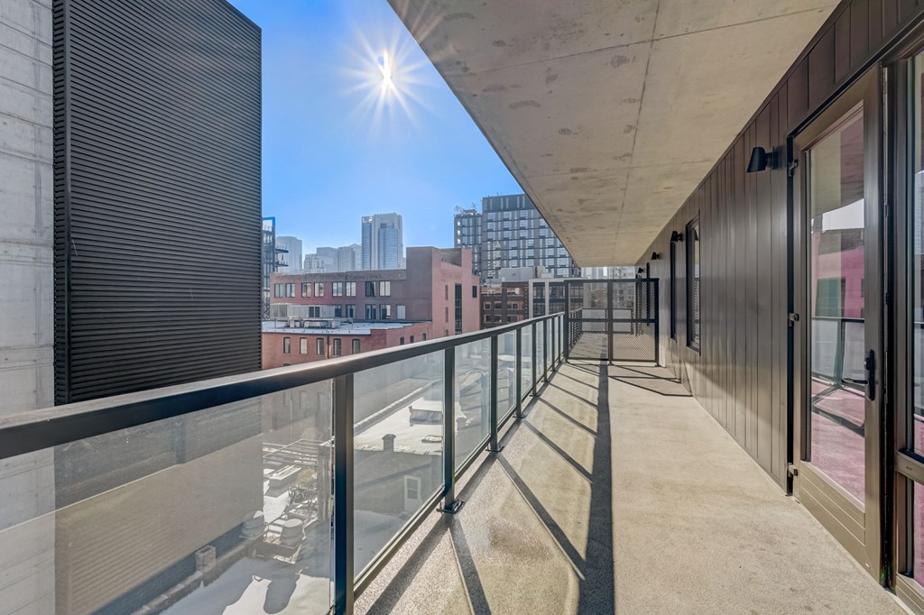 A sunny day on a balcony with a view of the city.