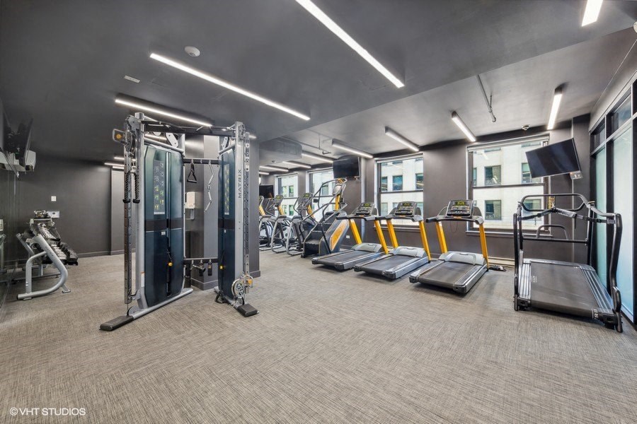 the gym is equipped with cardio equipment and weights