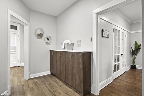 a living room with a counter and a door into a hallway