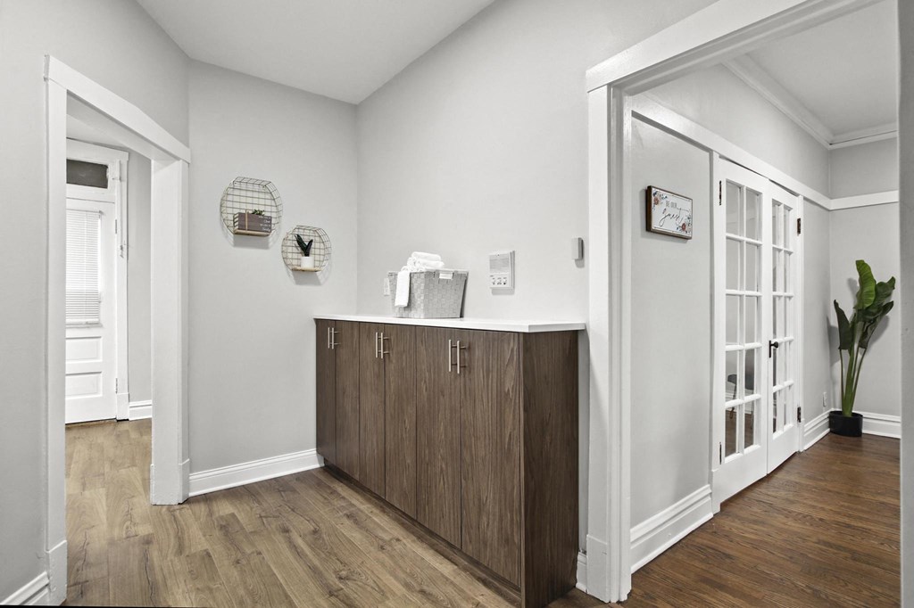 a living room with a counter and a door into a hallway