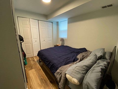 A bedroom with a bed and a wardrobe.