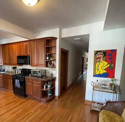 A kitchen with wooden cabinets and a white refrigerator.