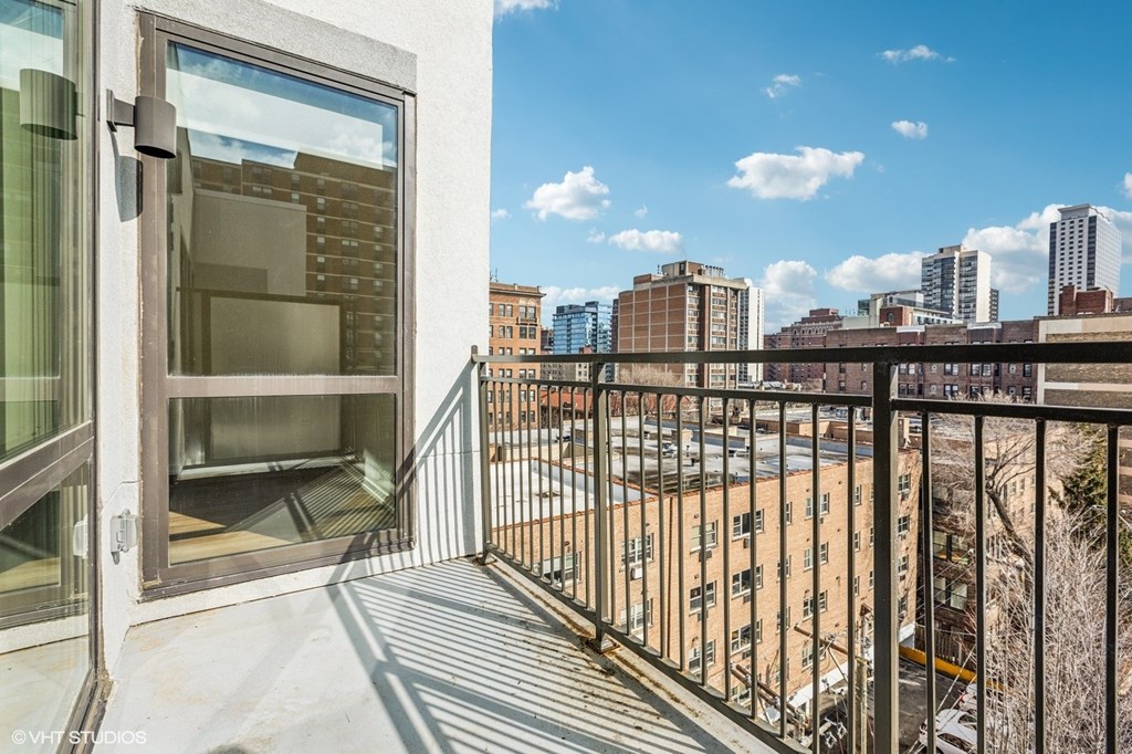A balcony with a view of a cityscape.