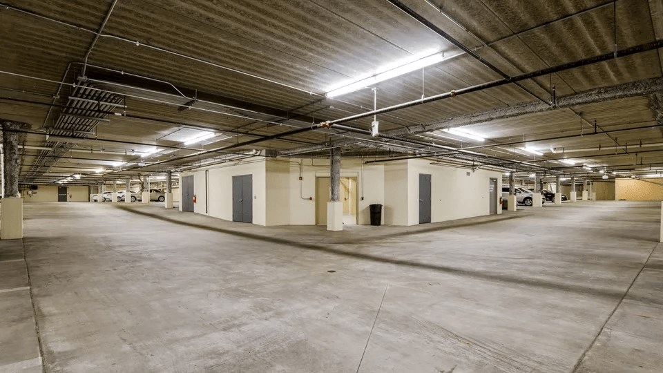 A large, empty warehouse with concrete floors and a high ceiling.