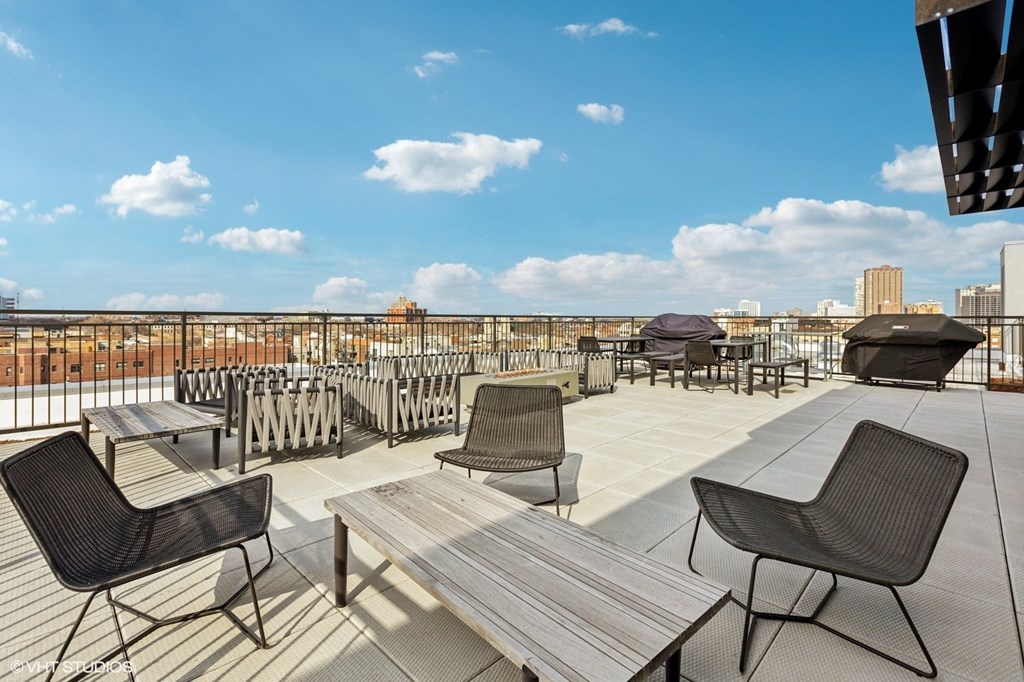 A patio with black chairs and a table.