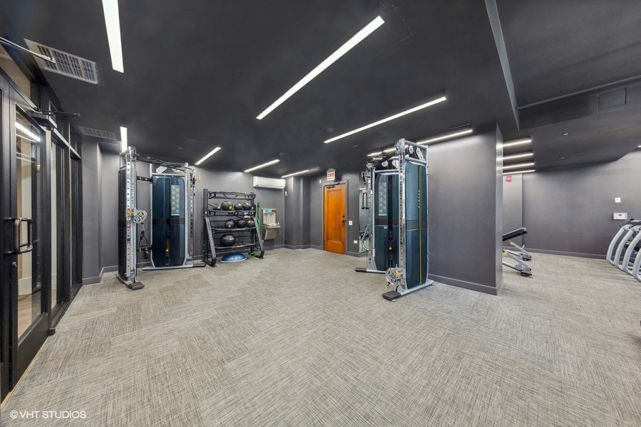 a gym with cardio equipment and mirrors in a building