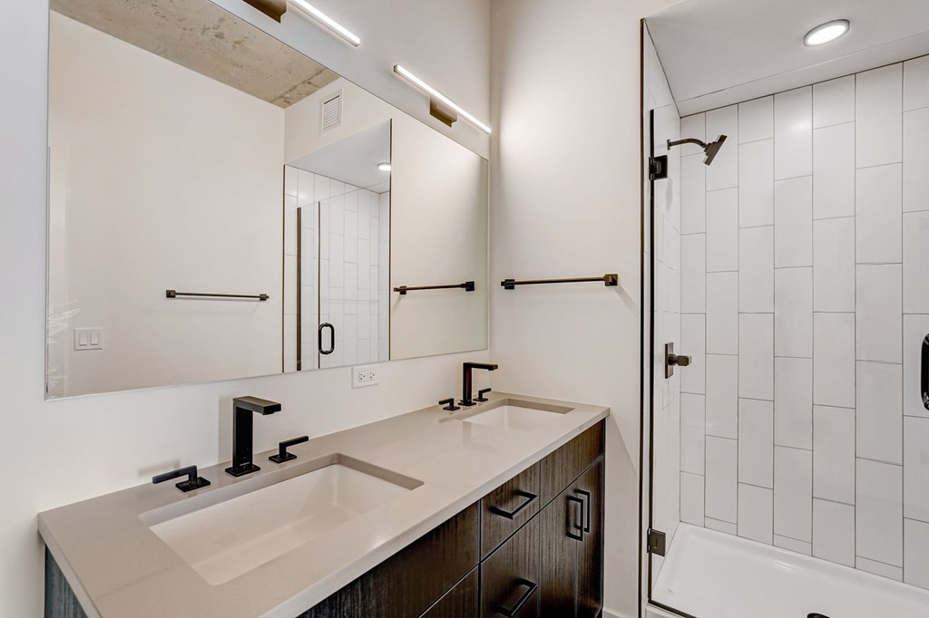 A bathroom with a sink and mirror.
