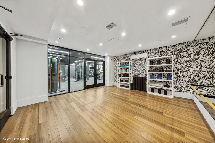a store with a wood floor and a wall of glass doors