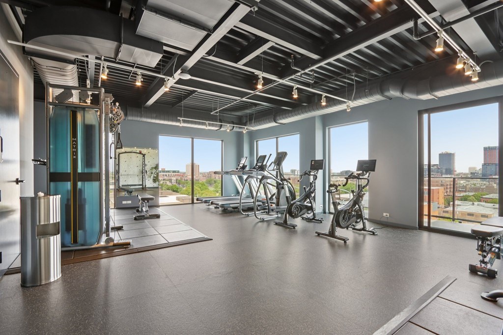A gym with a view of the city skyline.