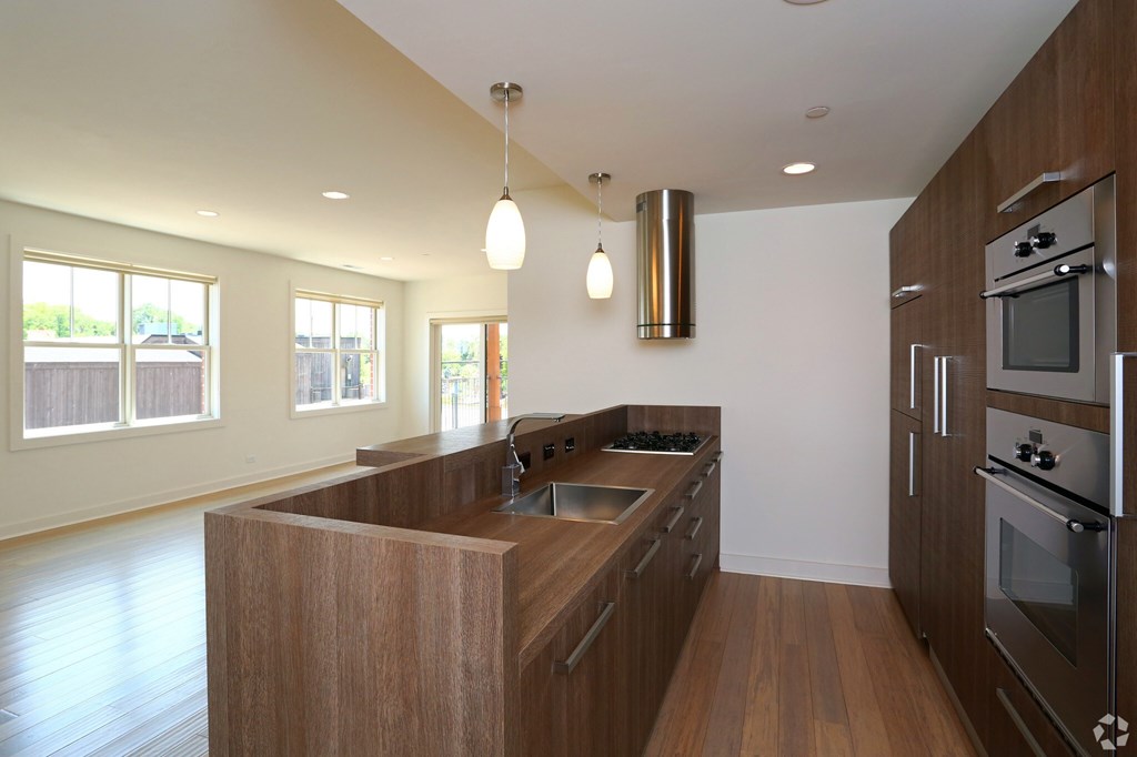 A modern kitchen with wooden cabinets and stainless steel appliances.