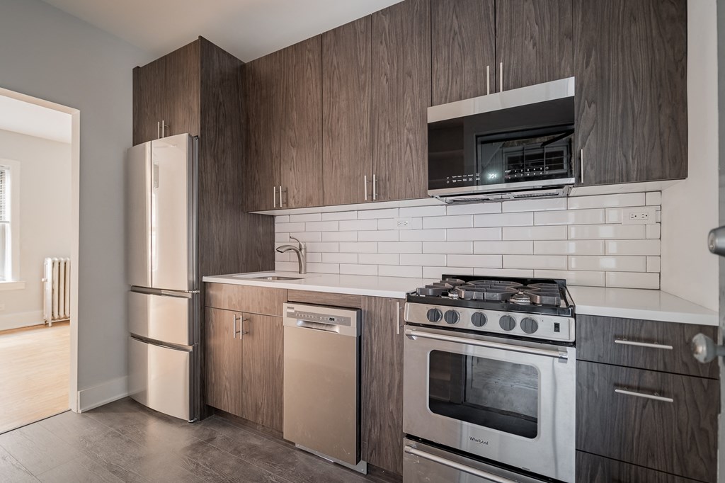 a kitchen with stainless steel appliances and wooden cabinets