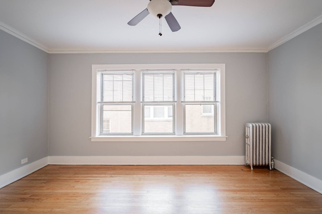 an empty room with a radiator and a window