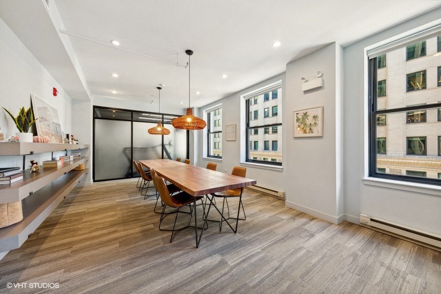 a dining room with a wooden table and chairs