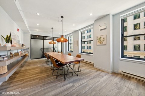 a dining room with a wooden table and chairs