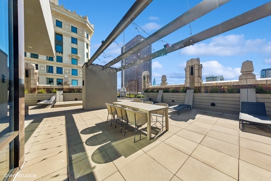 a patio with a table and chairs on a roof
