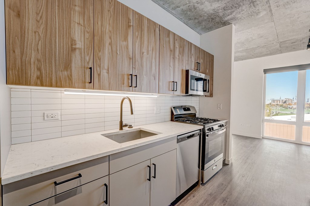 A kitchen with wooden cabinets and a white countertop.
