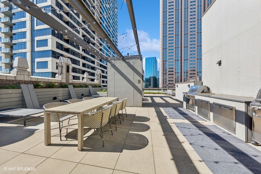 a patio with a table and chairs on a balcony