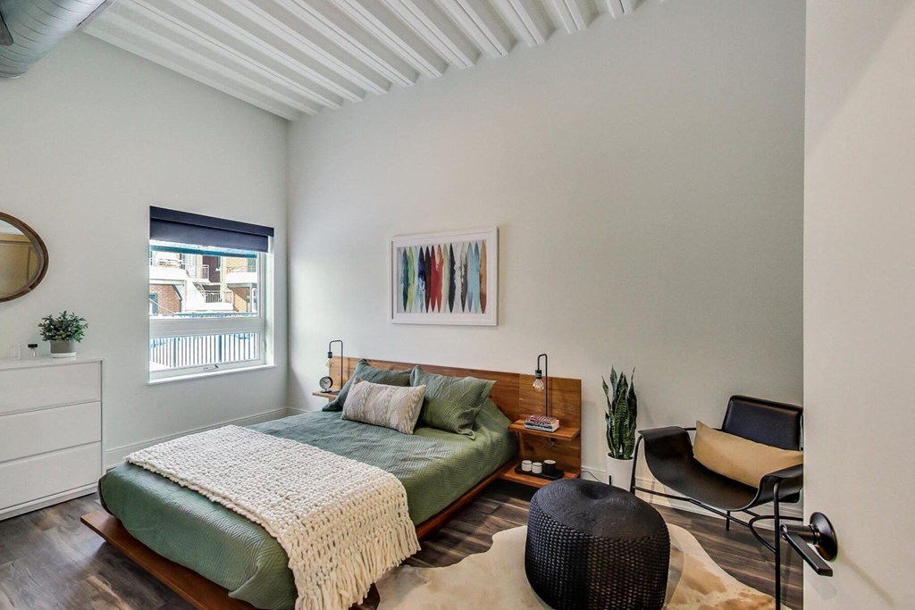 a bedroom with a bed and a window