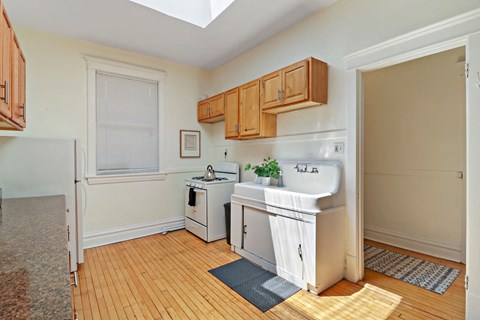 a kitchen with a sink and a stove and a refrigerator