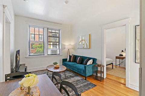 A living room with a blue couch and a television.