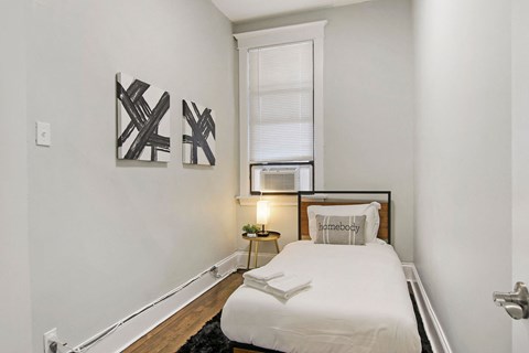 a small bedroom with a bed and a window