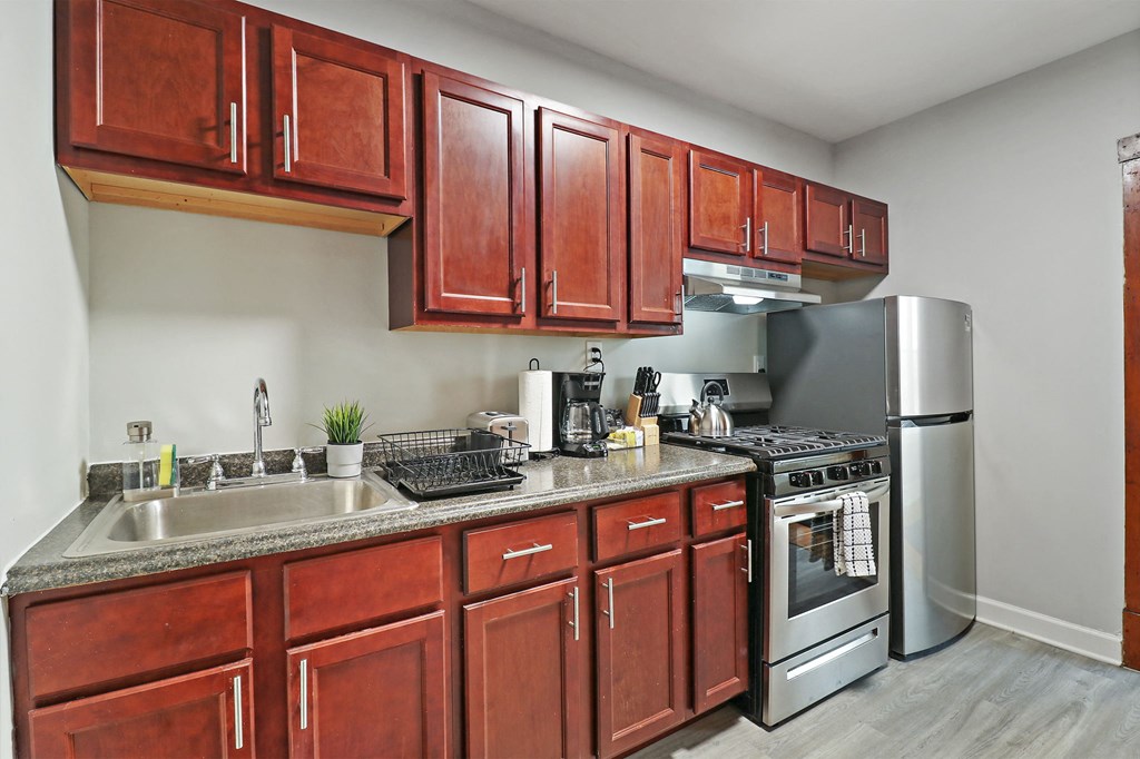 a kitchen with stainless steel appliances and wooden cabinets