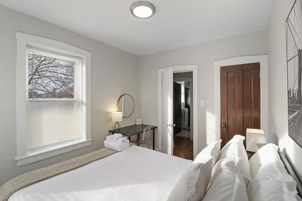 a bedroom with a large bed and a window