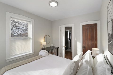 a bedroom with a large bed and a window