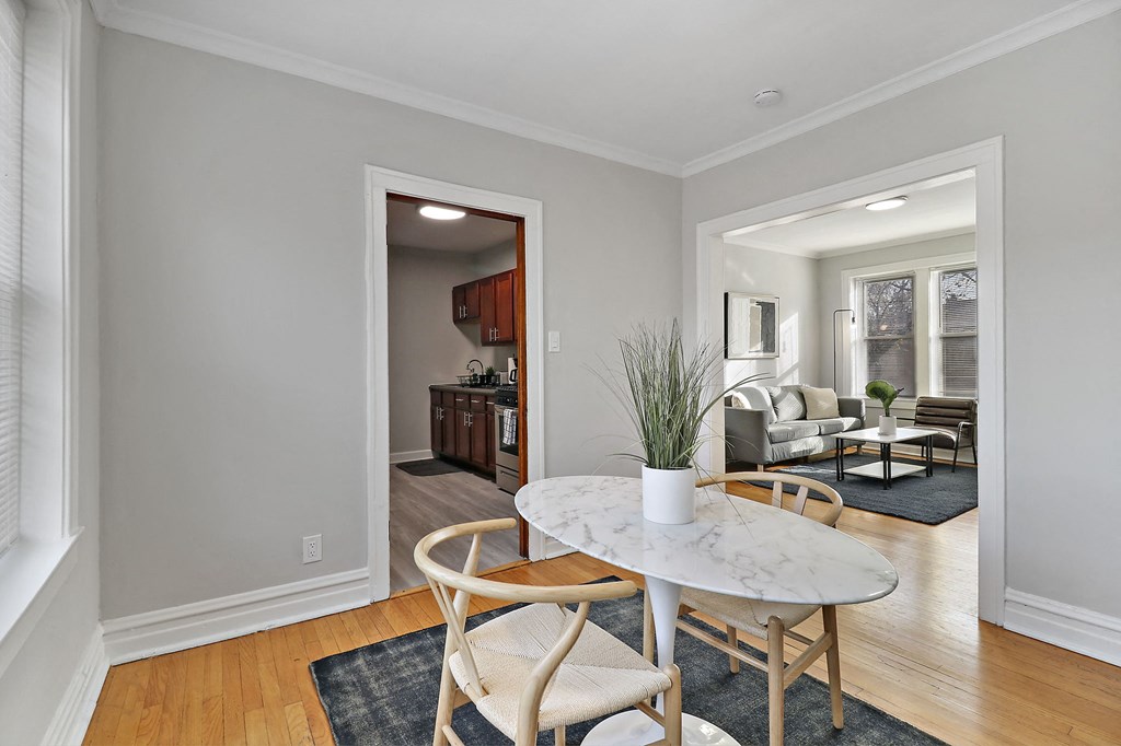 a dining room with a table and chairs and a living room