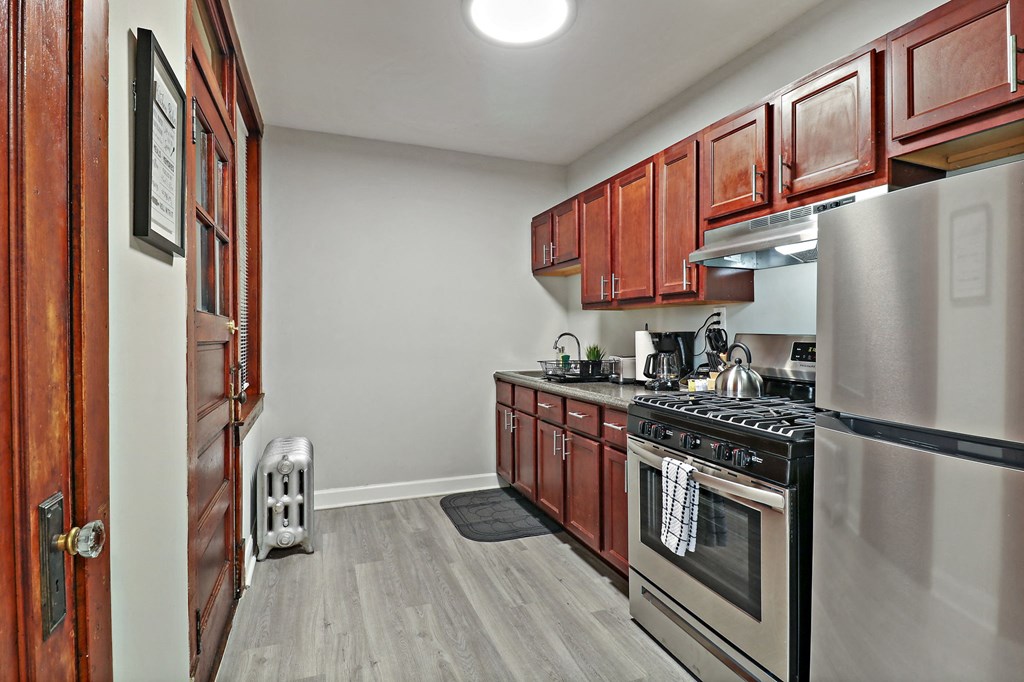 a kitchen with stainless steel appliances and wooden cabinets