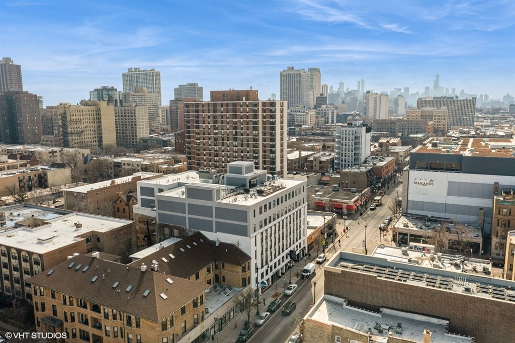 A cityscape with buildings and a clear sky.