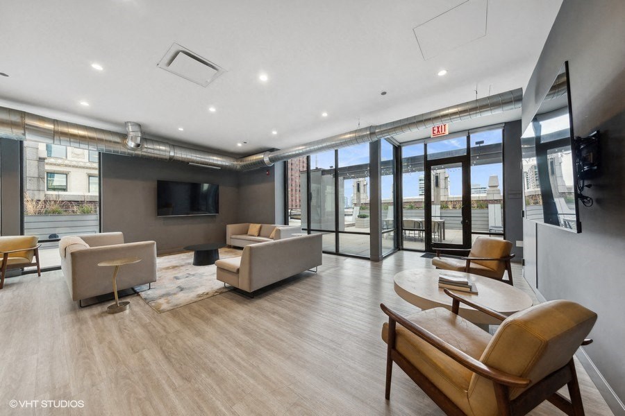 a room with a bunch of chairs and boxes on the floor