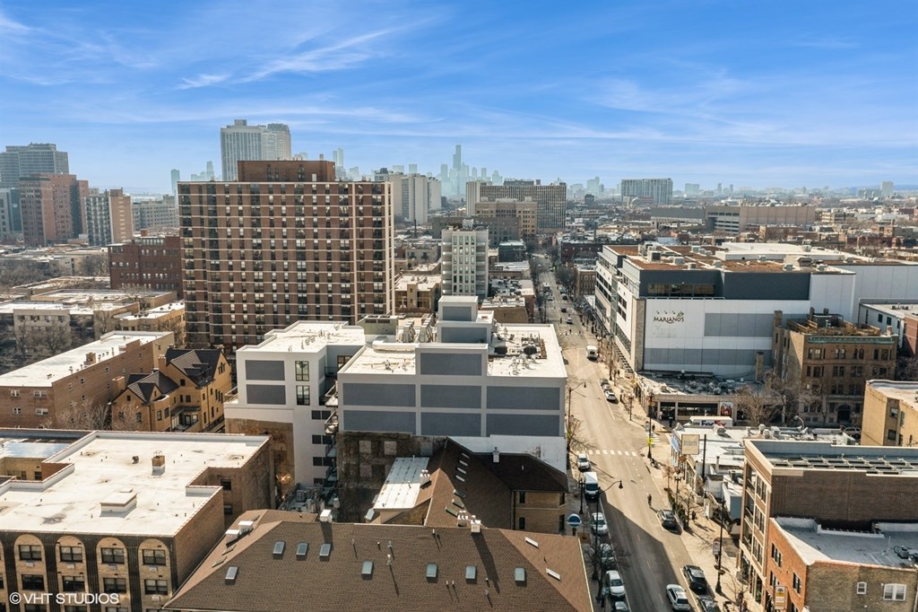 A cityscape with buildings and a clear sky.